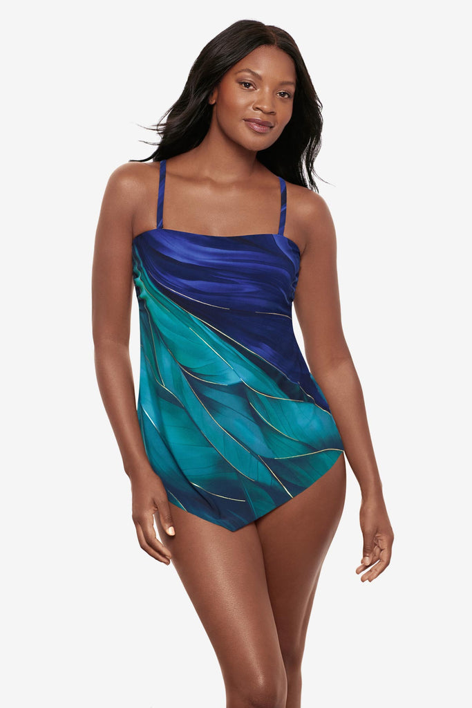 Woman wearing a multi-blue bandeau tankini top with gold detail