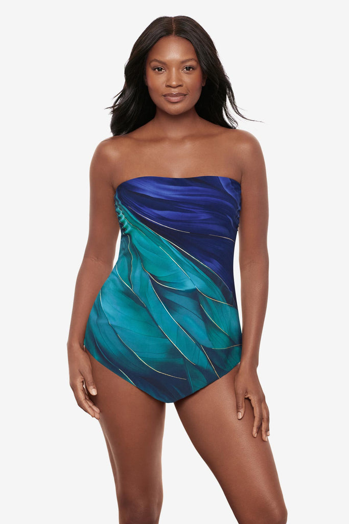 Woman wearing a multi-blue bandeau tankini top with gold detail