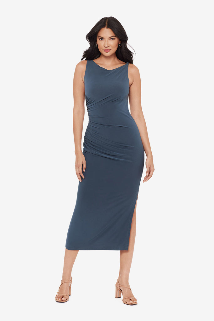Woman wearing a slate grey maxi dress with ruching on the side