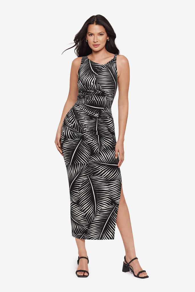 Woman wearing a black and white dress with a palm leaf print