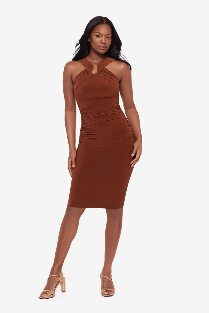Woman wearing a bronze brown midi dress with a high neckline