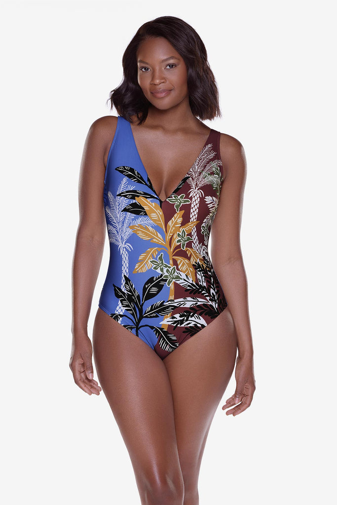 Woman wearing a multicolored and multi-printed one-piece swimsuit