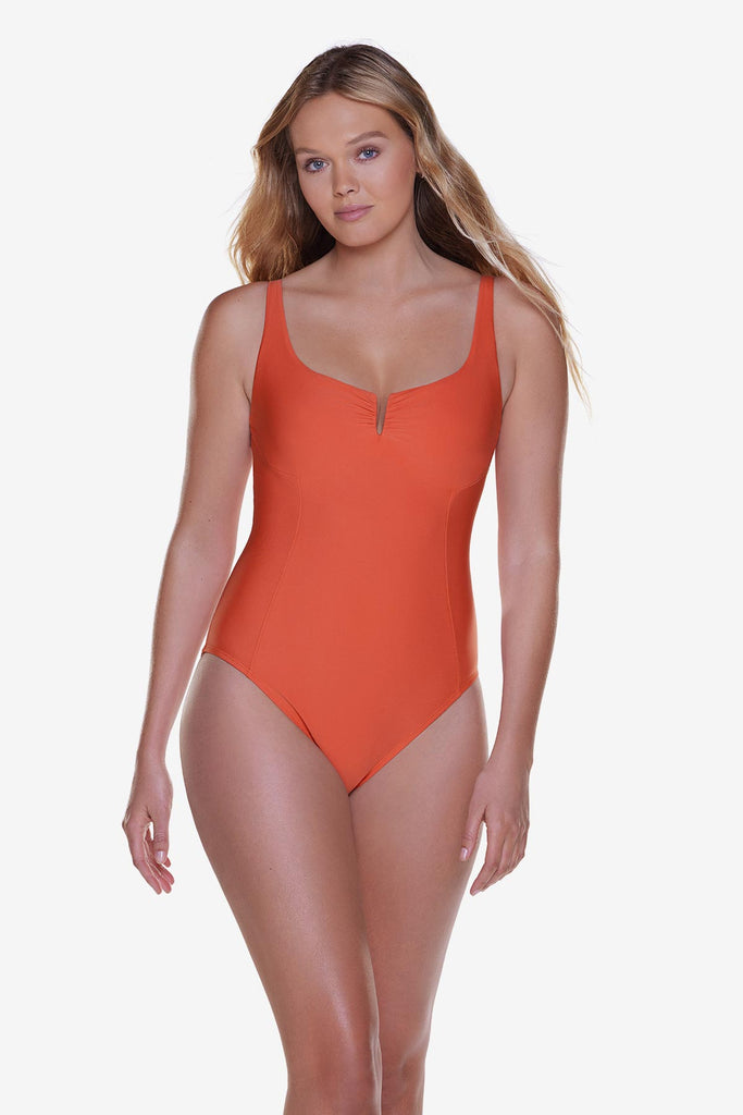 Woman wearing a solid orange one-piece swimsuit