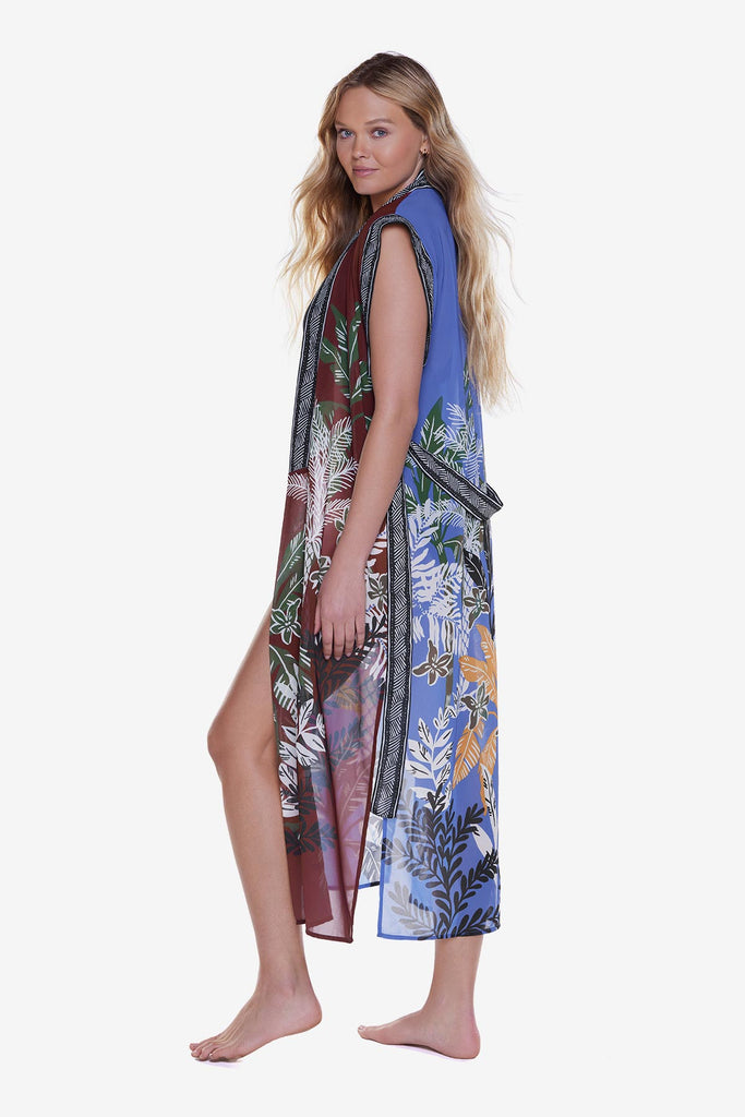 Woman turned left wearing a multicolored and printed duster swim cover up