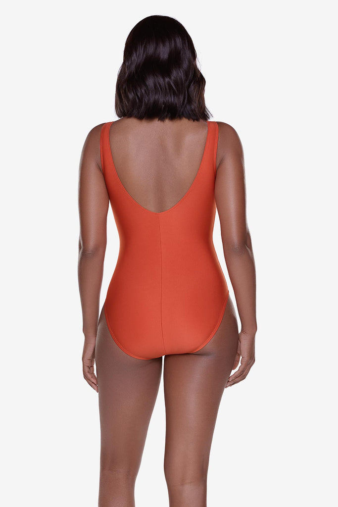 Woman turned away wearing an orange one-piece swimsuit