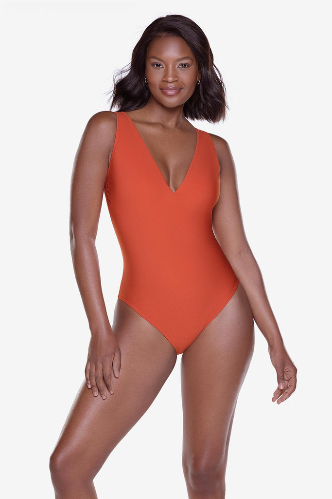 Woman wearing an orange one-piece swimsuit with a v-neckline