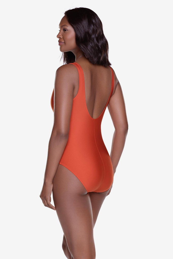 Woman wearing an orange one-piece swimsuit 