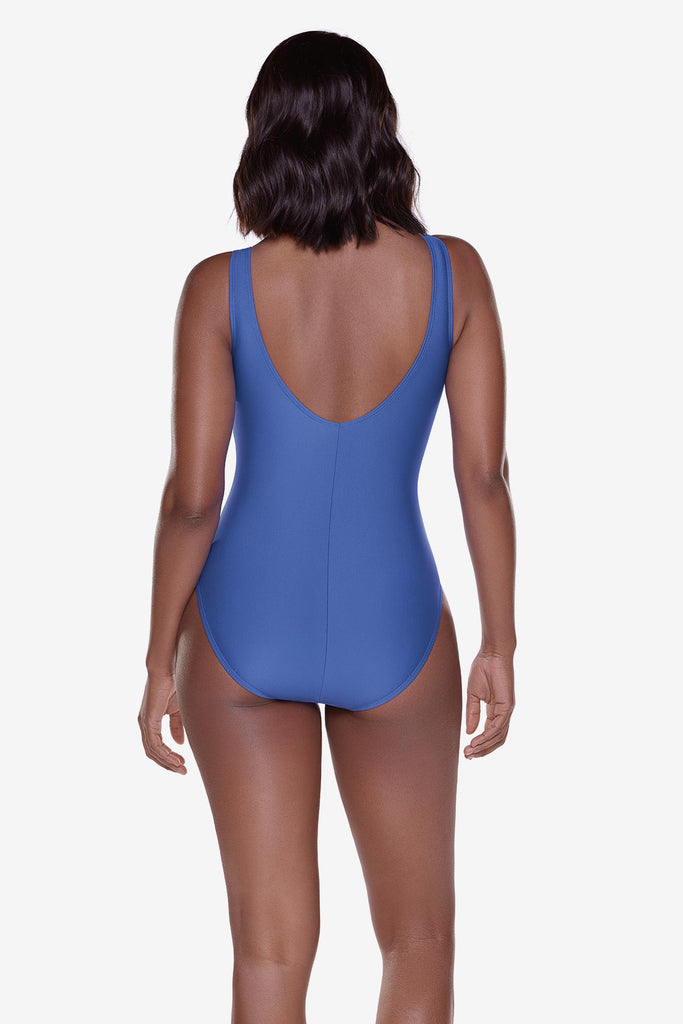 Woman turned away wearing a blue one-piece swimsuit 