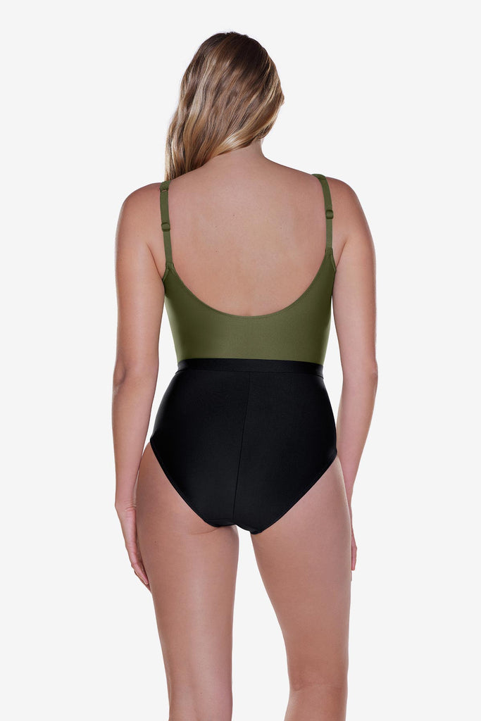 Woman turned away wearing a green and black one-piece swimsuit