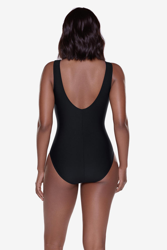 Woman turned away wearing a black one-piece swimsuit