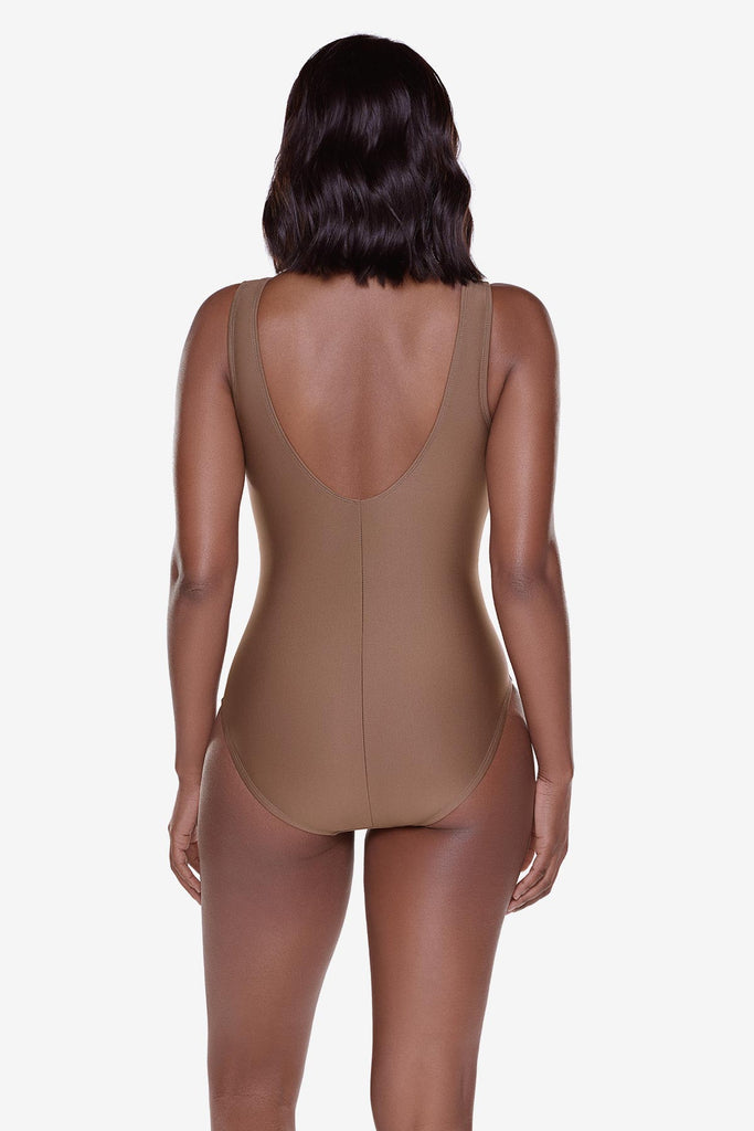 Woman turned away wearing a brown one-piece swimsuit