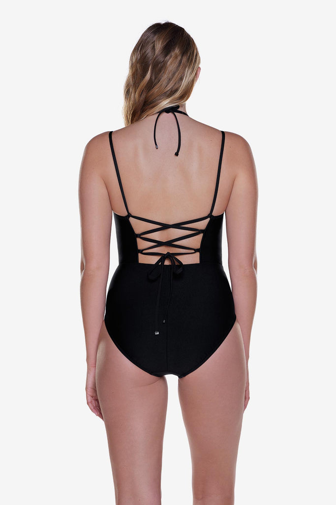 Woman turned away wearing a black one-piece swimsuit with X tie back