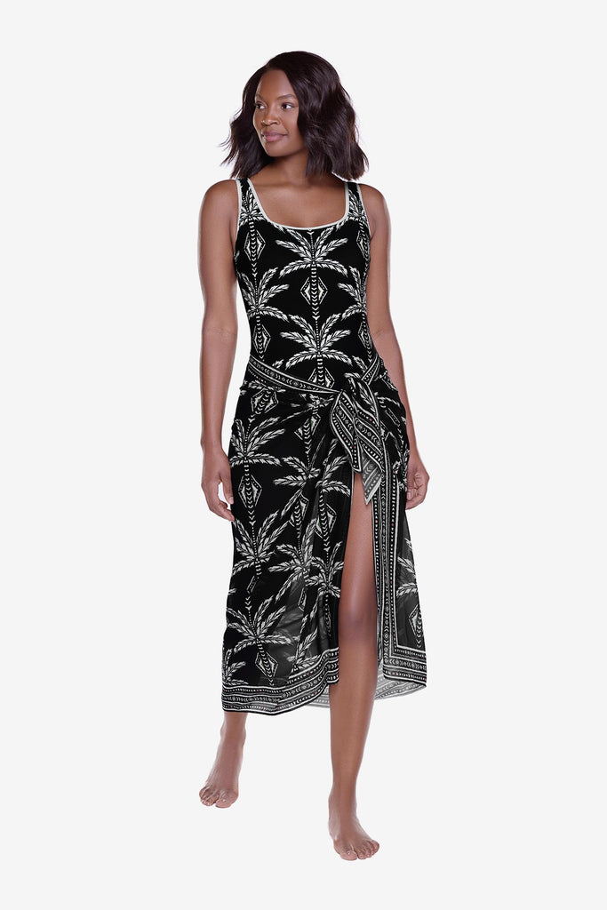 Woman wearing a black and white print swim cover up around her waist