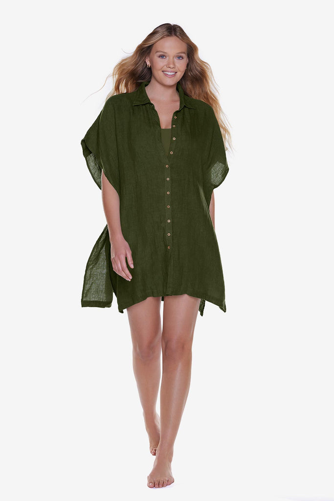 Woman wearing a dark green oversized swim shirt cover up