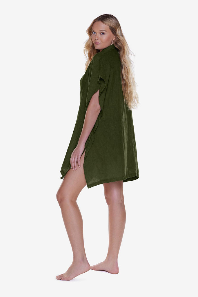 Woman faced left wearing a dark green oversized swim shirt cover up