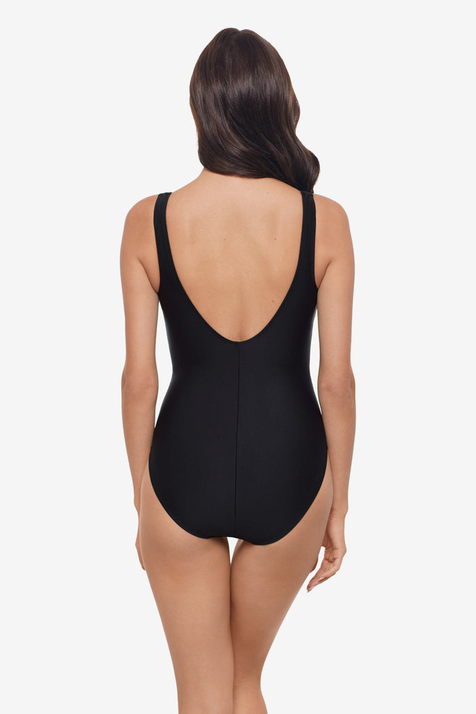 Woman faced away wearing a black one-piece swimsuit