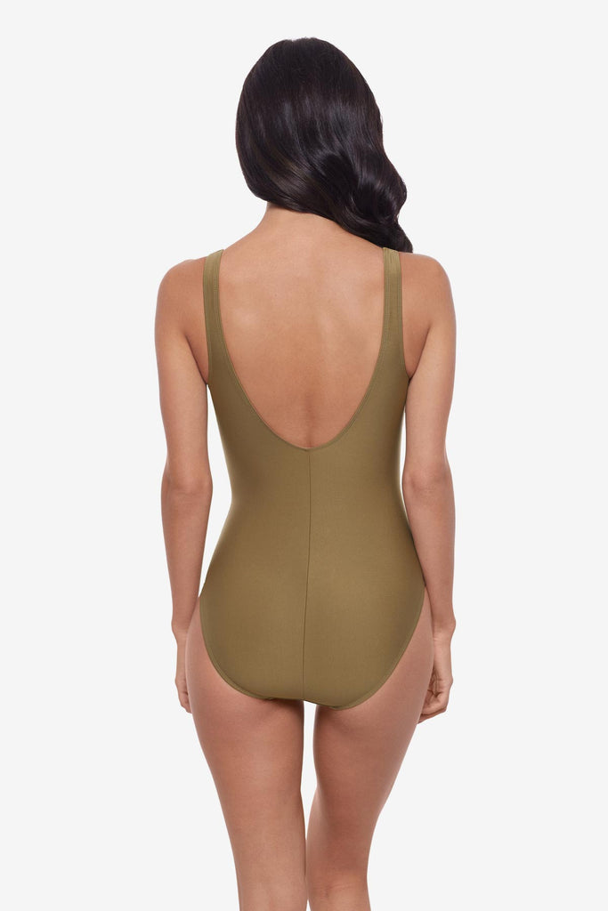 Woman turned away wearing a light brown one-piece swimsuit