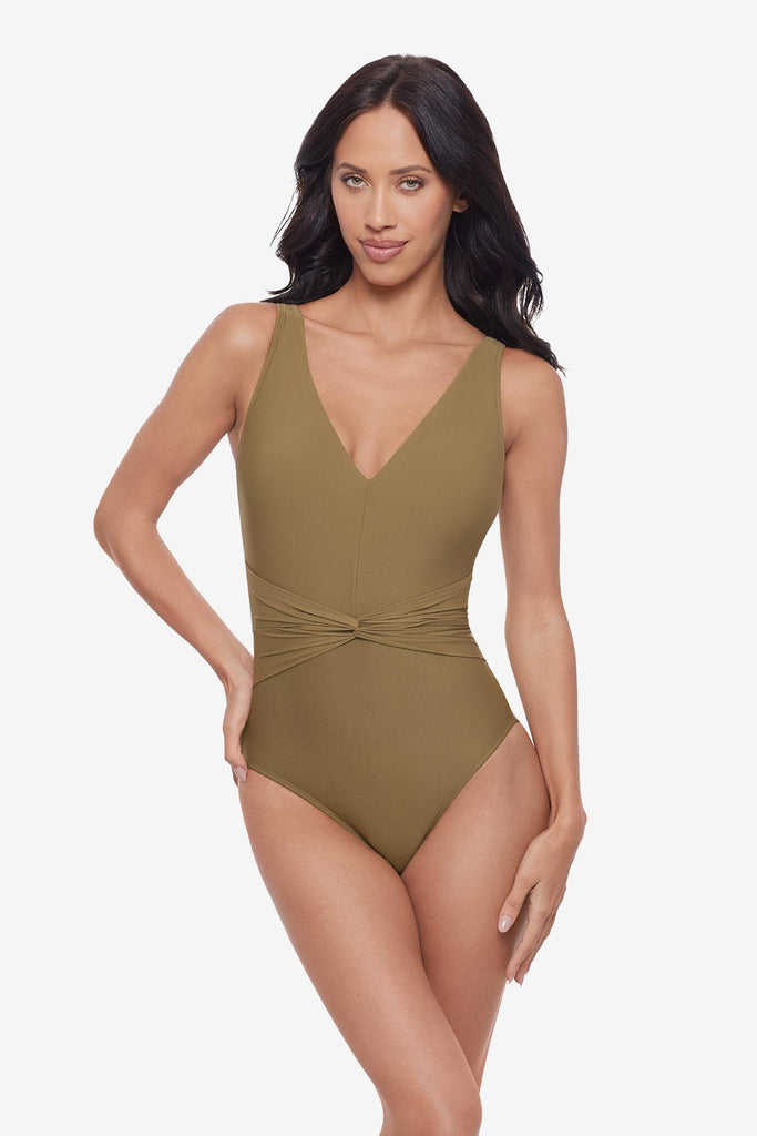 Woman wearing a light brown v-neck one-piece swimsuit