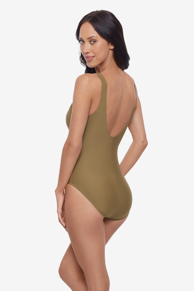 Woman turned left wearing a light brown one-piece swimsuit