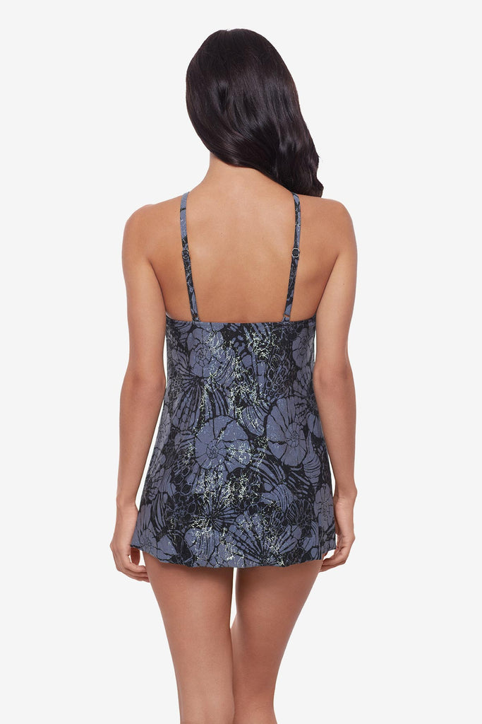 Woman turned away wearing a shimmery blue and black floral tankini top