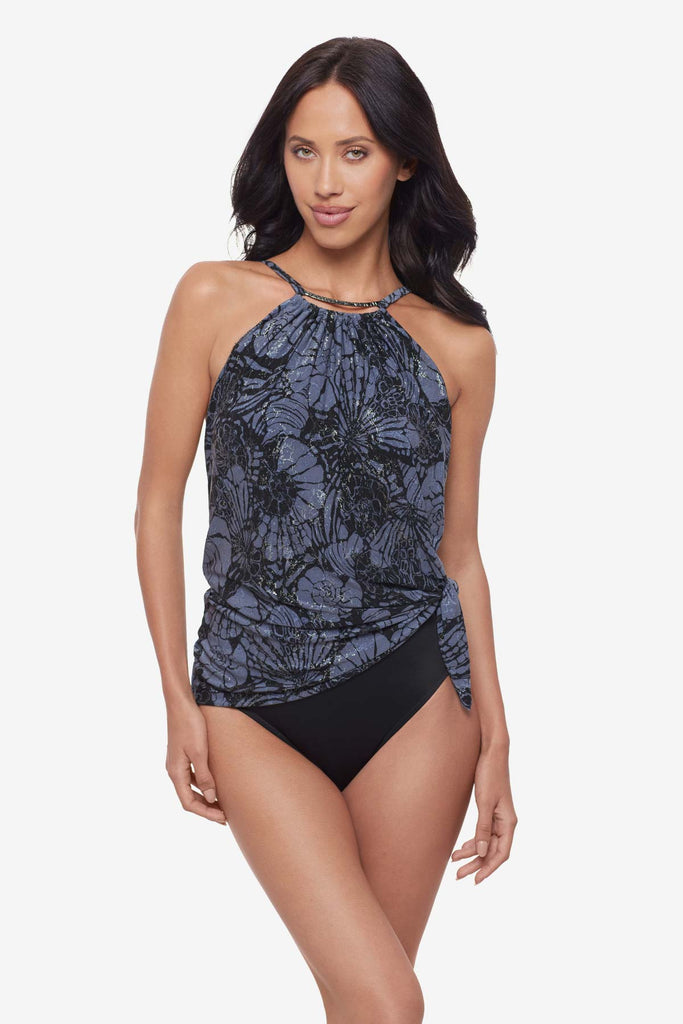 Woman wearing a shimmery blue and black floral tankini top