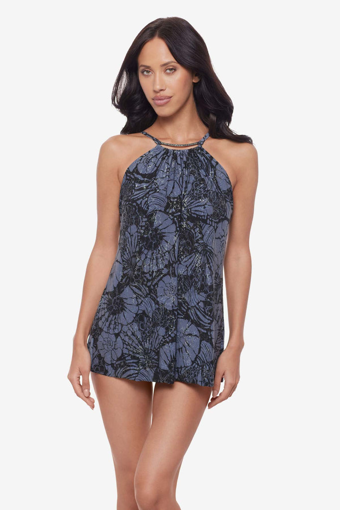 Woman wearing a shimmery blue and black floral tankini top