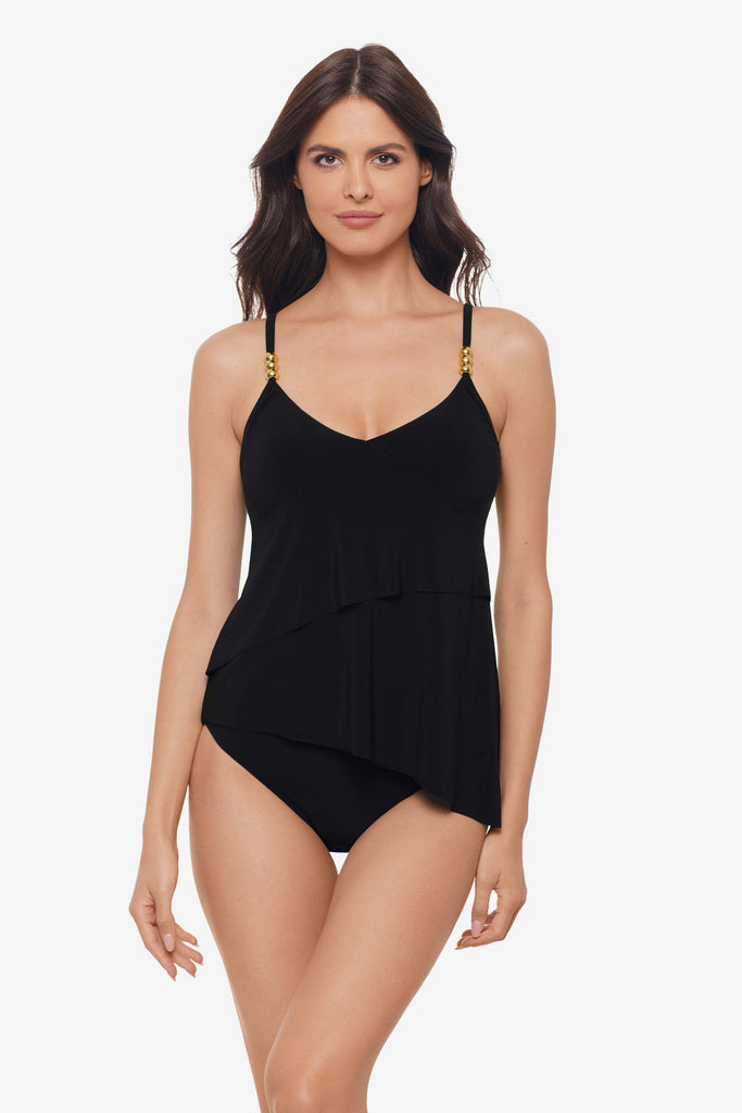 Woman wearing a black layered tankini top