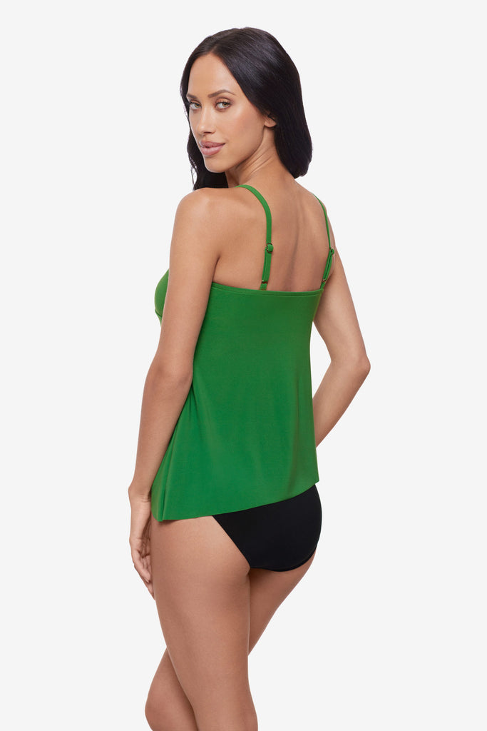 Woman turned left wearing a green layered tankini top