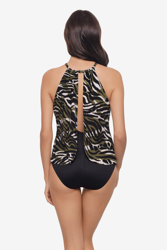 Woman turned away wearing a multicolored animal print one-piece swimsuit