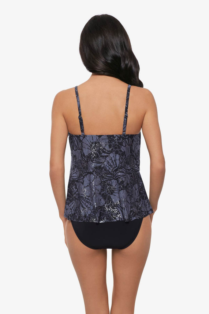 Woman turned away wearing a shimmery tankini top with blue shells