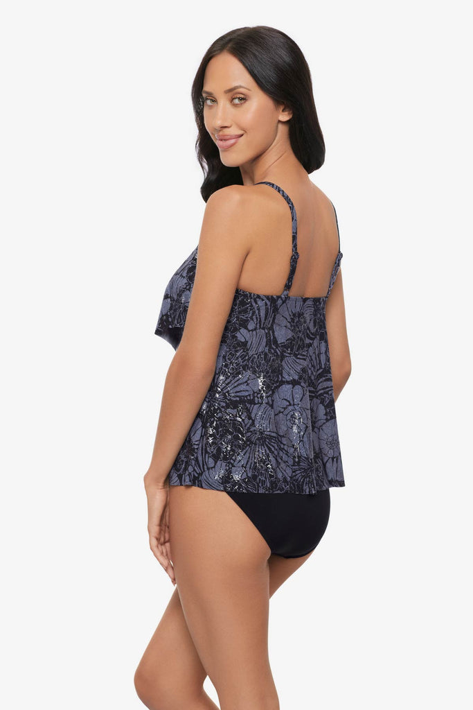 Woman turned left wearing a shimmery tankini top with blue shells