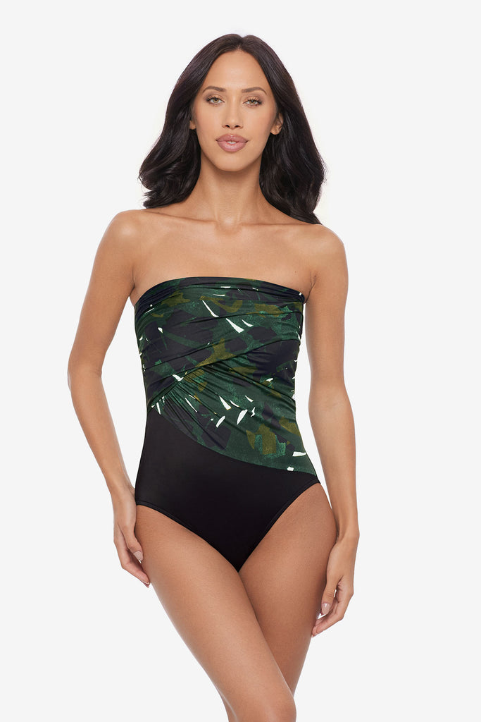 Woman wearing a bandeau one-piece swimsuit with a palm leaf print