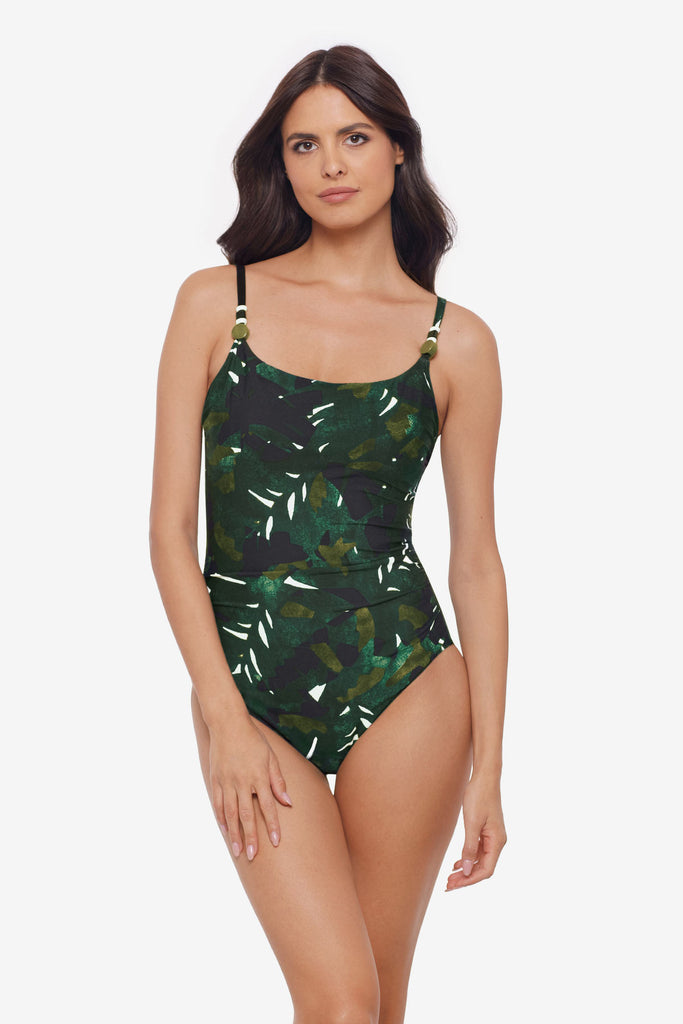 Woman wearing a one-piece swimsuit with a palm leaf print and beads on the straps