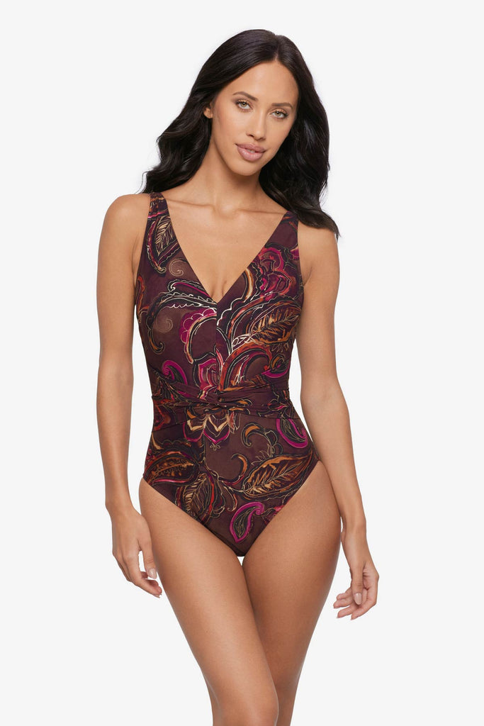 Woman wearing a multicolored paisley printed one-piece swimsuit