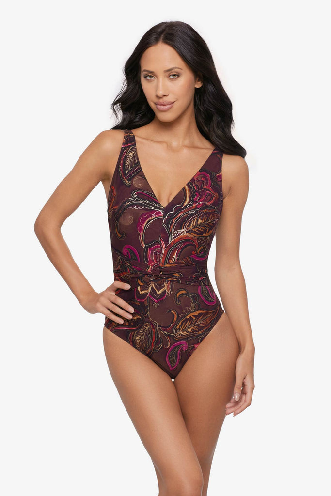 Woman wearing a multicolored paisley printed one-piece swimsuit