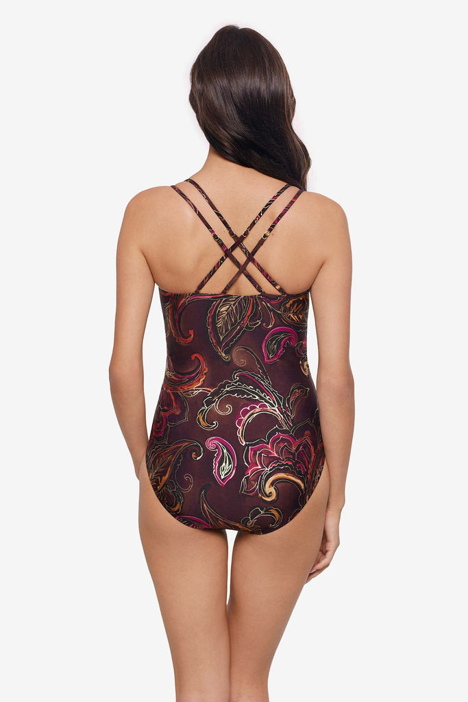 Woman turned away wearing a multicolored paisley printed one-piece swimsuit