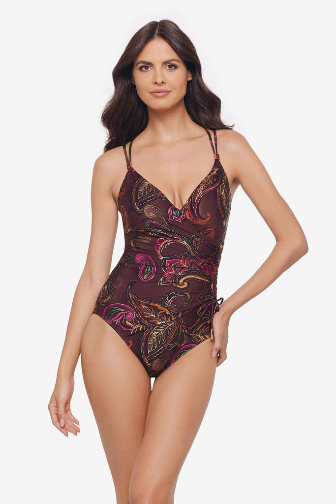 Woman wearing a multicolored paisley printed one-piece swimsuit