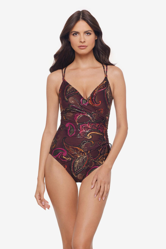 Woman wearing a multicolored paisley printed one-piece swimsuit