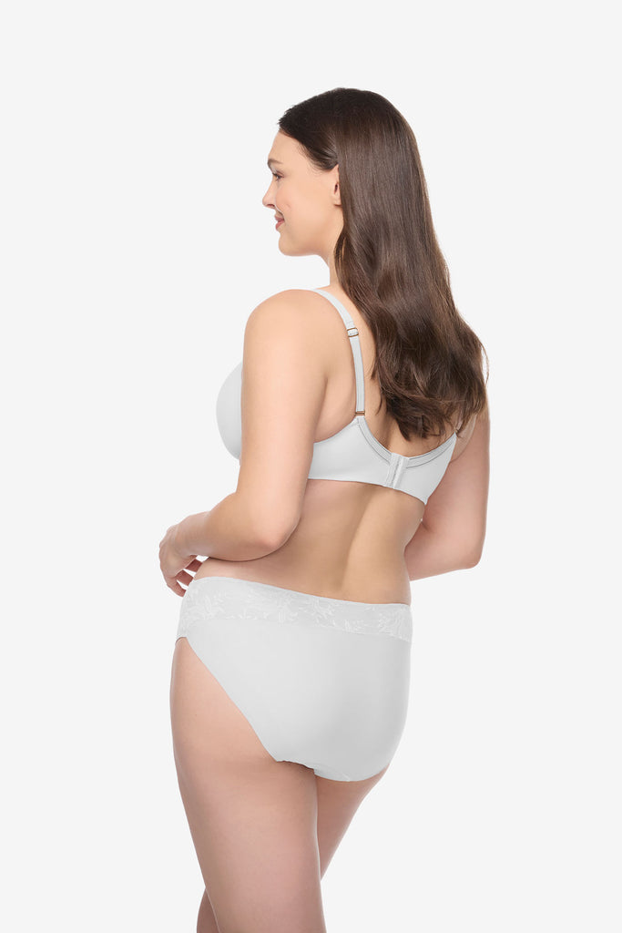 Woman angled away wearing a white bra and underwear set