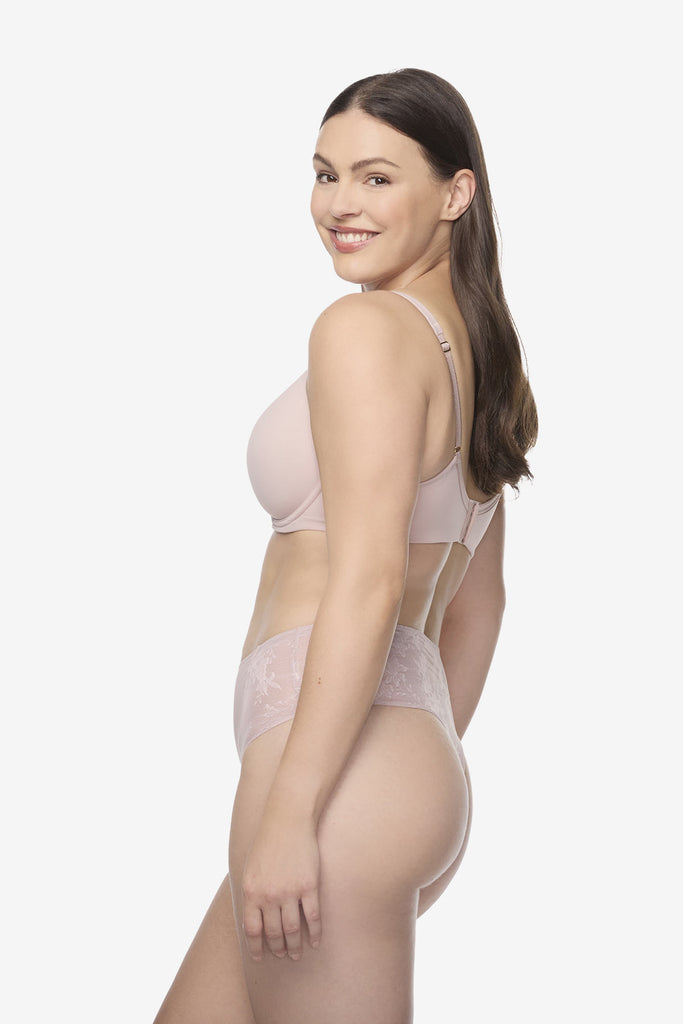 Woman turned left wearing light pink thong shapewear