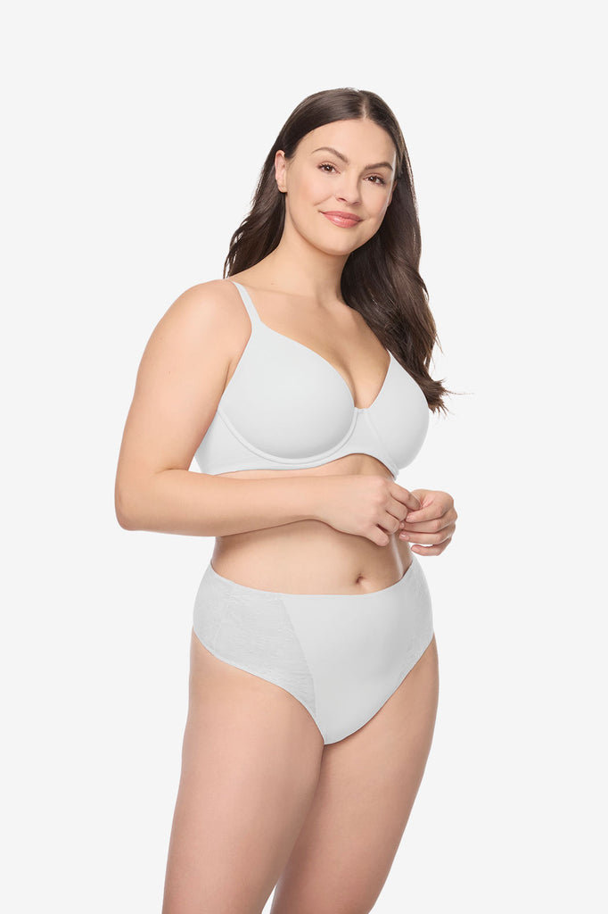 Woman wearing a white bra and high waisted thong underwear set