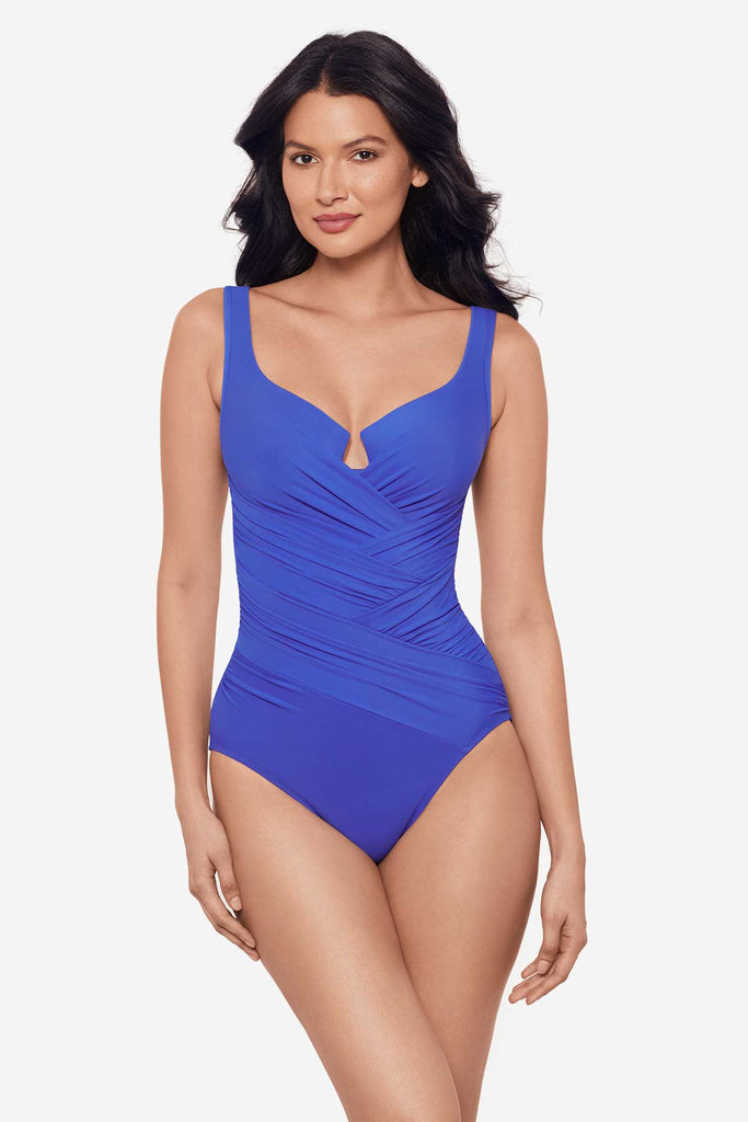 Woman wearing a delphine blue one-piece swimsuit with a sweetheart neckline