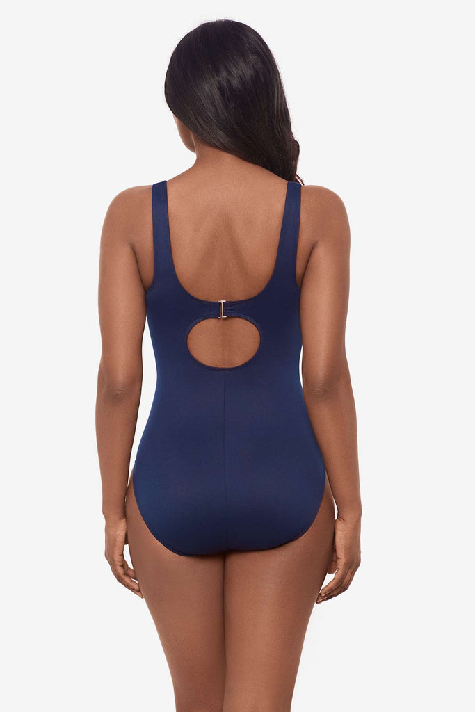 Woman face away to show clasp in back of swimsuit