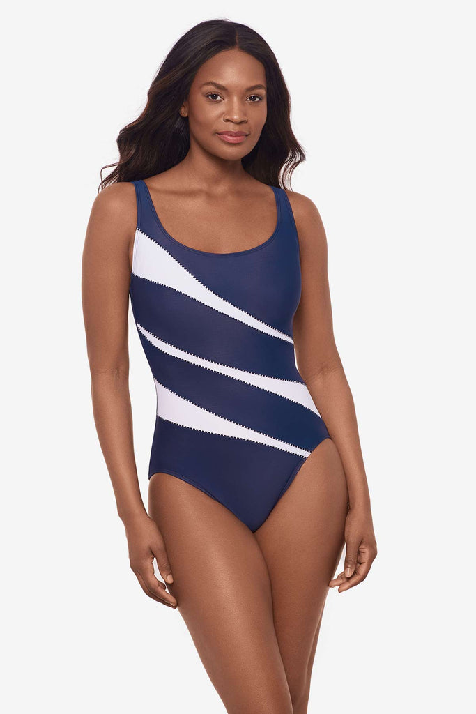 Woman wearing a one-piece blue and white swimsuit