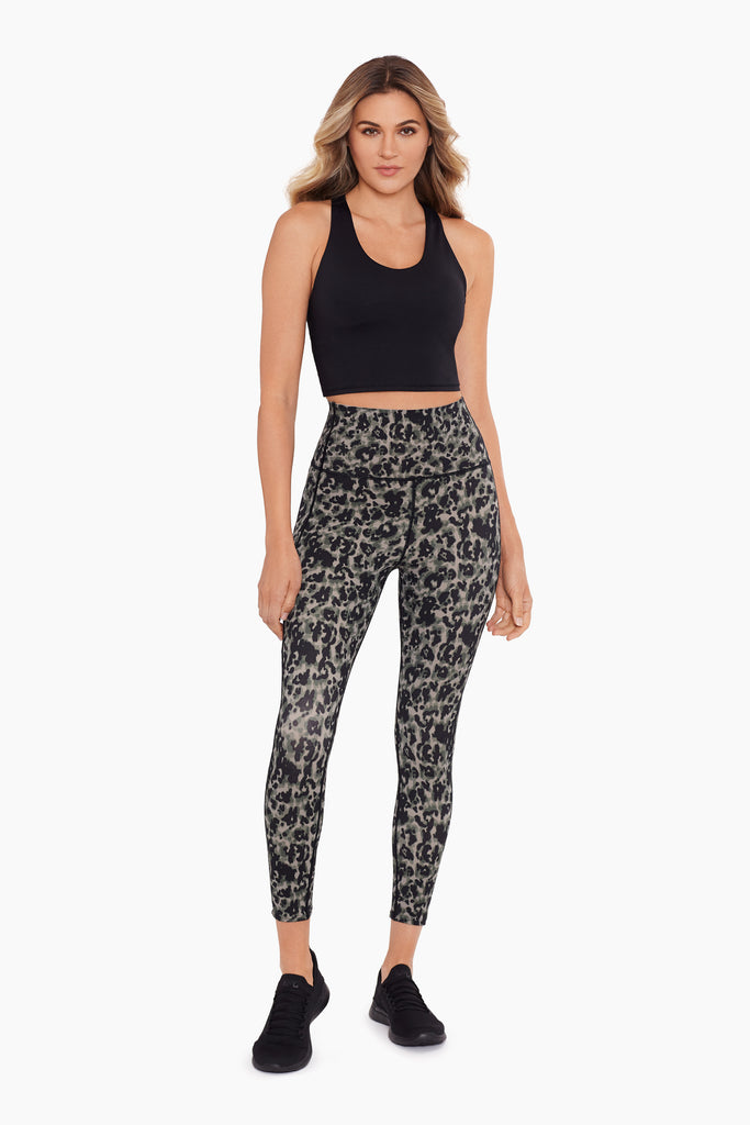 Girl wearing a tummy control printed leggings.
