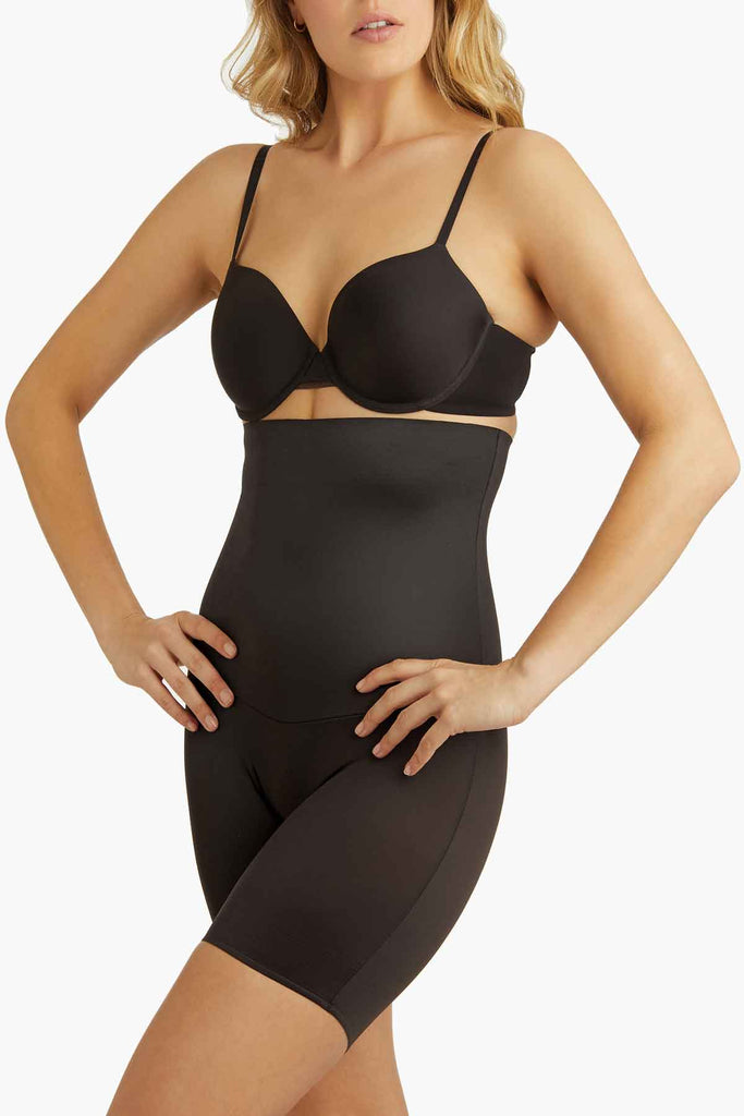 Woman wearing a high waist thigh slimmer shapewear.