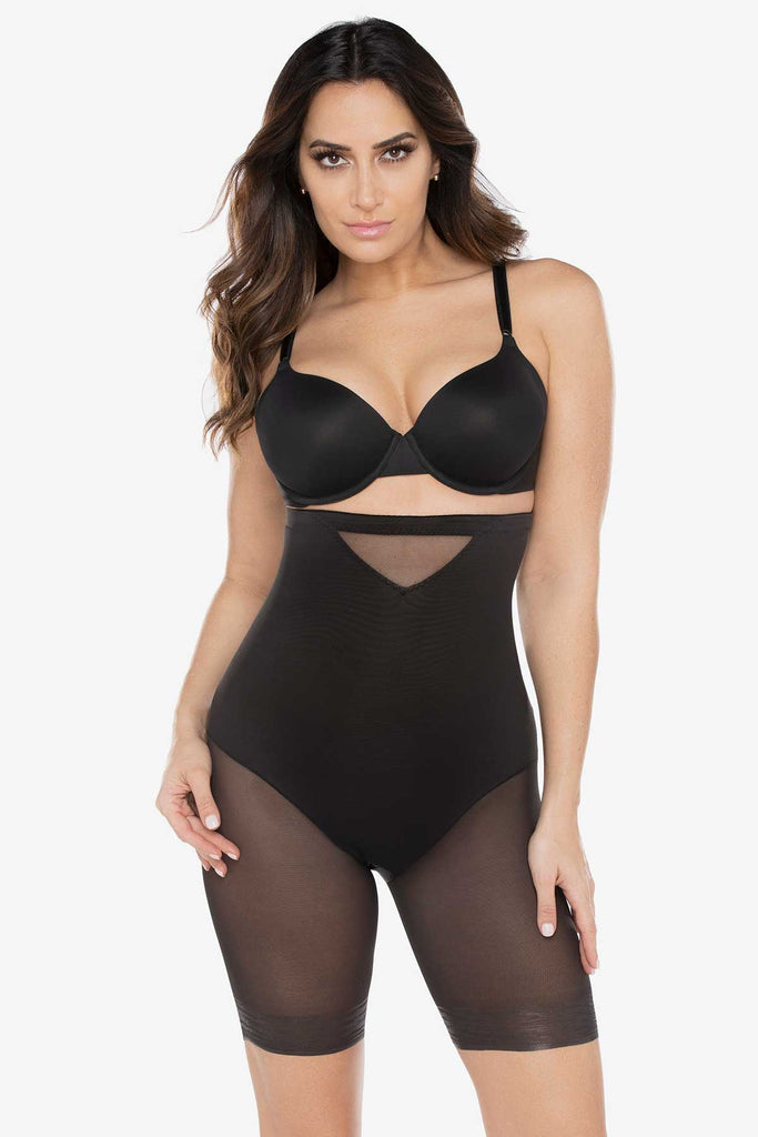 Woman wearing a sexy sheer high waist thigh slimmer.