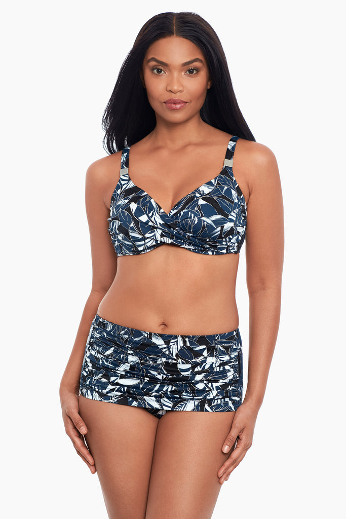 Woman wearing a miracle suit swim suit.