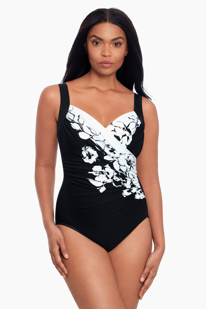 Woman in a sanibel one piece swim suit.